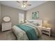 Comfortable bedroom with a white bed, turquoise bedding, large dresser and a round mirror on top at 4542 Cedar Brush Ter, Sarasota, FL 34243
