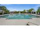 Community pool featuring lounge chairs, umbrellas and well-manicured landscaping at 4542 Cedar Brush Ter, Sarasota, FL 34243