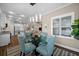 Charming dining area with modern light fixture conveniently located near the living and kitchen at 4542 Cedar Brush Ter, Sarasota, FL 34243