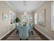 Elegant dining area with bright natural light, modern pendant lighting, and seating for four at 4542 Cedar Brush Ter, Sarasota, FL 34243