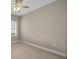 Empty room with neutral colored walls and trim, tile flooring, a ceiling fan with lights, and a window at 4542 Cedar Brush Ter, Sarasota, FL 34243