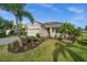 Beautifully landscaped front yard with palm trees enhancing the curb appeal of this lovely home at 4542 Cedar Brush Ter, Sarasota, FL 34243