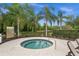 A cozy hot tub area, perfect for relaxation amidst lush landscaping and serene lake views at 4542 Cedar Brush Ter, Sarasota, FL 34243