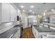 Bright, modern kitchen with an island, stainless steel appliances, and view to the open living area at 4542 Cedar Brush Ter, Sarasota, FL 34243