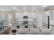 Modern kitchen boasts white cabinetry, dark countertops, and an island with bar seating at 4542 Cedar Brush Ter, Sarasota, FL 34243