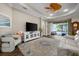 Comfortable living room features a ceiling fan, dark wood floors, and glass sliding doors to the outside at 4542 Cedar Brush Ter, Sarasota, FL 34243