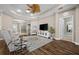 Bright living area with a ceiling fan, dark wood floors, and a view of the front entrance at 4542 Cedar Brush Ter, Sarasota, FL 34243