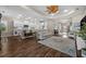 Open living area with hardwood floors, ceiling fan, and seamless flow to the kitchen for modern living at 4542 Cedar Brush Ter, Sarasota, FL 34243
