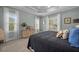 Beautiful bedroom with two windows, large dresser, tray ceiling and a comfortable bed with blue and gold decorative pillows at 4542 Cedar Brush Ter, Sarasota, FL 34243