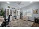 Bright home office with built-in bookcase, stylish decor, and plantation shutters at 4542 Cedar Brush Ter, Sarasota, FL 34243