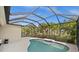Enclosed pool area featuring a screened-in lanai and lush tropical landscaping for a relaxing and private outdoor experience at 4542 Cedar Brush Ter, Sarasota, FL 34243