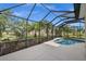 The screened pool area offers privacy and shade, providing an outdoor oasis surrounded by mature trees at 4542 Cedar Brush Ter, Sarasota, FL 34243