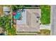 Overhead view of screened pool with red umbrella and surrounding deck and patio area at 5126 15Th W Ave, Bradenton, FL 34209