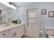 Charming bathroom featuring a white vanity, natural light, and blue walls at 5126 15Th W Ave, Bradenton, FL 34209