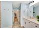 Hallway bathroom with white vanity, designer mirror, and tiled shower at 5126 15Th W Ave, Bradenton, FL 34209