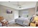 Cozy bedroom with a ceiling fan, a rocking chair, and a peaceful view at 5126 15Th W Ave, Bradenton, FL 34209