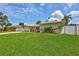 Lovely single-story home featuring a lush green lawn, landscaping, and a white fence for privacy at 5126 15Th W Ave, Bradenton, FL 34209