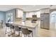 Bright kitchen featuring granite countertops, stainless steel appliances, a breakfast bar, and white cabinets at 5126 15Th W Ave, Bradenton, FL 34209