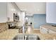 Bright kitchen with granite countertops, stainless steel appliances and mosaic backsplash at 5126 15Th W Ave, Bradenton, FL 34209