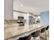 Bright kitchen with granite countertops, stainless steel appliances, seating at breakfast bar and white cabinets at 5126 15Th W Ave, Bradenton, FL 34209