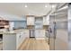 Bright kitchen with granite countertops, stainless steel appliances, white cabinets and mosaic tile backsplash at 5126 15Th W Ave, Bradenton, FL 34209