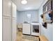Functional laundry room with modern appliances and storage, making chores a breeze at 5126 15Th W Ave, Bradenton, FL 34209