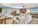 Comfortable living room featuring a brick fireplace, a ceiling fan, and ample seating at 5126 15Th W Ave, Bradenton, FL 34209