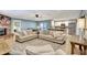 Open concept living room with a brick fireplace flowing into an updated kitchen with stainless steel appliances at 5126 15Th W Ave, Bradenton, FL 34209