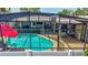 Enclosed pool with clear blue water, poolside furniture, and a red umbrella for shade at 5126 15Th W Ave, Bradenton, FL 34209