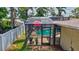 Enclosed pool with an umbrella and lush greenery in the background at 5126 15Th W Ave, Bradenton, FL 34209