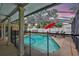 Relaxing screened-in pool area featuring lounge chairs, umbrella, and a secure fence for added safety and privacy at 5126 15Th W Ave, Bradenton, FL 34209