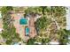Overhead shot reveals the property's layout with pool, carport, and mature trees enhancing privacy and appeal at 5204 24Th E Ave, Palmetto, FL 34221