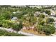Aerial view captures the property's generous space and layout, nestled amongst lush greenery and mature trees at 5204 24Th E Ave, Palmetto, FL 34221