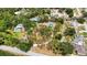 High aerial view shows property with large lot featuring trees and pool and a large covered carport at 5204 24Th E Ave, Palmetto, FL 34221