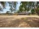 Vast backyard showcasing a covered carport and screened pool, creating an ideal outdoor space at 5204 24Th E Ave, Palmetto, FL 34221