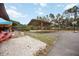 Large backyard with a covered area, ideal for parking, activities or outdoor storage at 5204 24Th E Ave, Palmetto, FL 34221