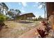 Spacious backyard with a covered parking area and mature landscaping at 5204 24Th E Ave, Palmetto, FL 34221