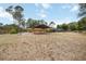 Expansive backyard featuring a covered parking area and screened-in pool, perfect for outdoor activities at 5204 24Th E Ave, Palmetto, FL 34221