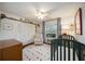 Charming Bedroom with a crib and closet; round rug adds pops of color at 5204 24Th E Ave, Palmetto, FL 34221