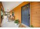 Charming home featuring a covered porch with rocking chairs and a stylish blue front door at 5204 24Th E Ave, Palmetto, FL 34221