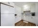 A well-lit kitchen features white cabinets, modern appliances, and ample counter space, perfect for cooking and entertaining at 5204 24Th E Ave, Palmetto, FL 34221