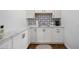 Kitchen features a double sink, white cabinets, backsplash, and ample counter space at 5204 24Th E Ave, Palmetto, FL 34221