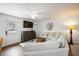 A cozy living room with comfortable seating, a ceiling fan, and a large TV, perfect for relaxation and entertainment at 5204 24Th E Ave, Palmetto, FL 34221