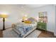 A serene main bedroom with wood-look floors, neutral tones, and ample natural light, creating a relaxing retreat at 5204 24Th E Ave, Palmetto, FL 34221