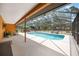 Screened-in pool with outdoor seating, covered eating area and lush greenery at 5204 24Th E Ave, Palmetto, FL 34221
