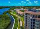 Aerial view of community buildings with dock, waterway and well-maintained landscaping at 5561 Cannes Cir # 5101, Sarasota, FL 34231