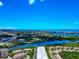 Picturesque aerial view of coastal community with waterways, lush greenery, and clear blue skies at 5561 Cannes Cir # 5101, Sarasota, FL 34231