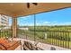Screened balcony with views of the river, lush vegetation, and comfortable patio furniture at 5561 Cannes Cir # 5101, Sarasota, FL 34231