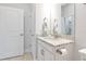 Bathroom vanity featuring granite countertops, white cabinets, and a decorative mirror at 5561 Cannes Cir # 5101, Sarasota, FL 34231