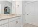 Bathroom features a granite countertop vanity, next to a closed door, with tile flooring at 5561 Cannes Cir # 5101, Sarasota, FL 34231